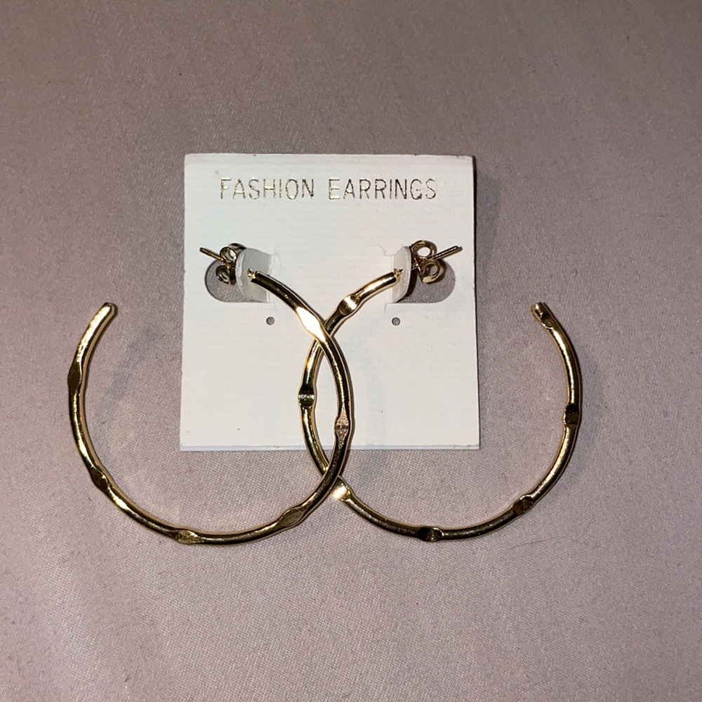Large hoop gold earrings with pressed design
